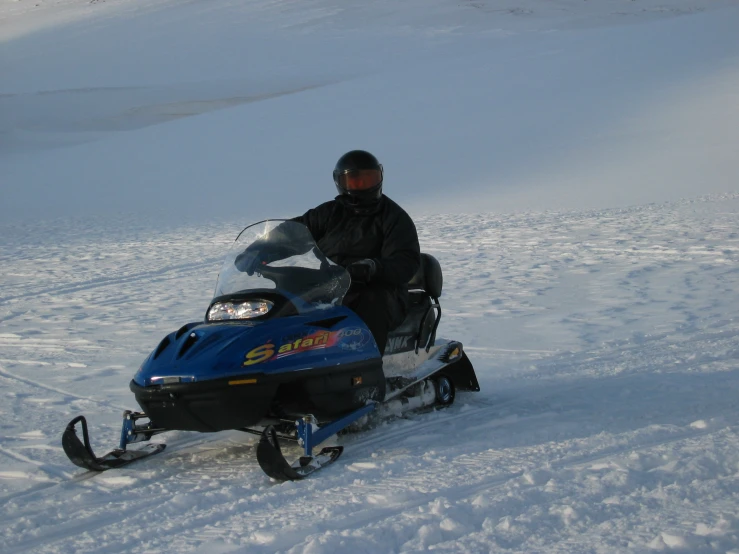 a person on a snow mobile on the snowy ground