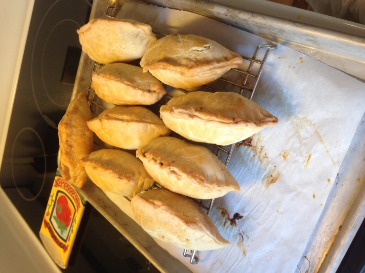 a tray of small pastries sitting on top of an oven