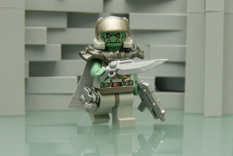 a toy with a gun and a green mask holding a knife