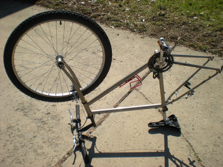 this is an upside down bicycle on the sidewalk