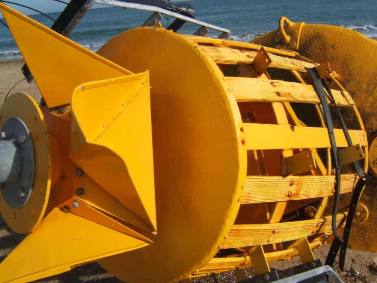 a big yellow machine sitting on the ground