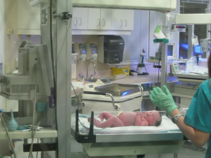 a woman is standing next to a hospital bed