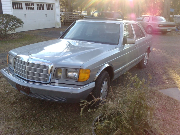 a large mercedes benz parked in a yard