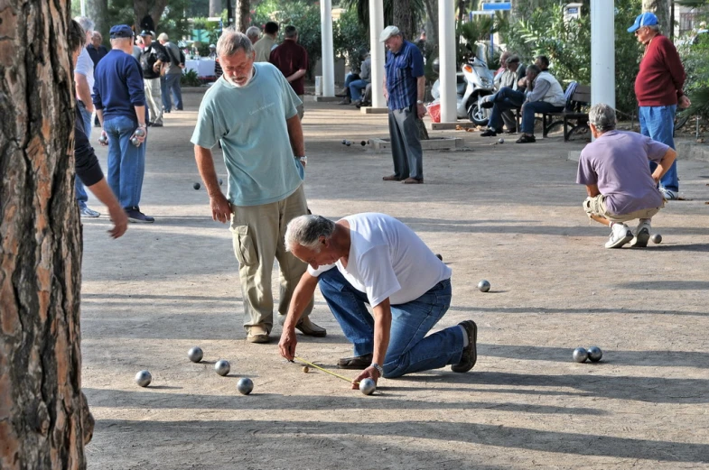 some people are playing with balls in the ground