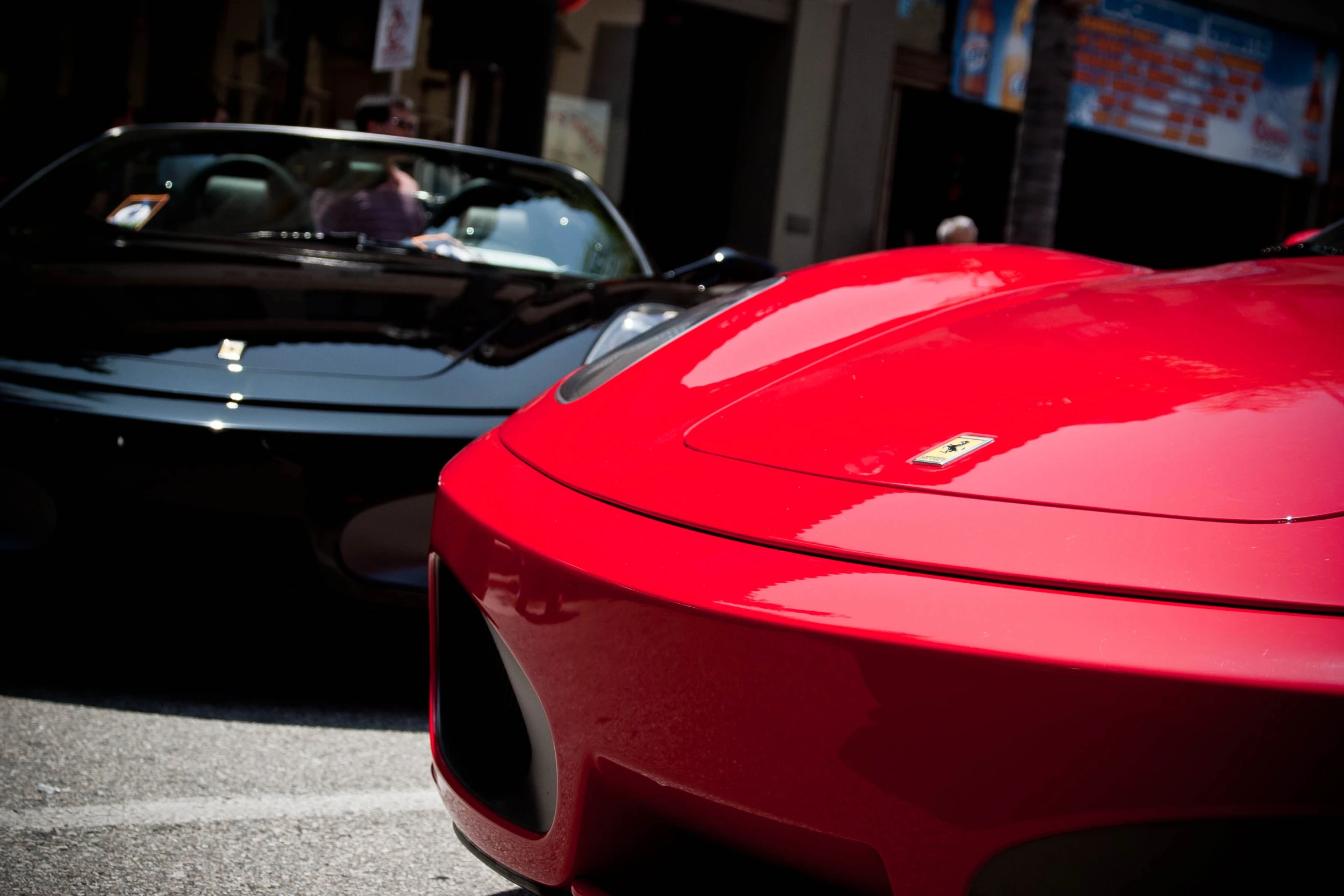 two cars that are sitting on the street