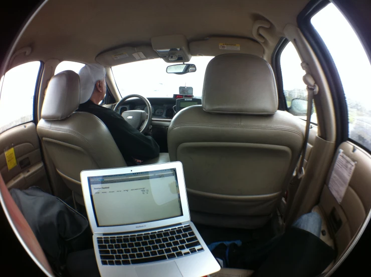 laptop sitting in the front row seat of a car