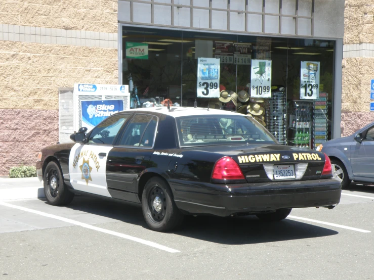the police car is parked near the curb