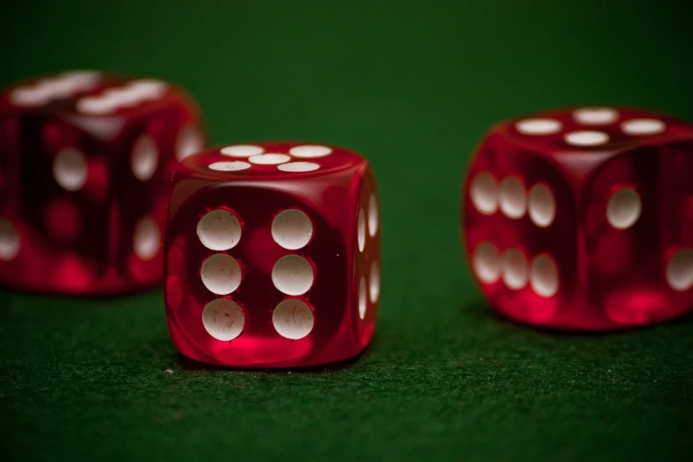 three red dices are sitting together on the ground