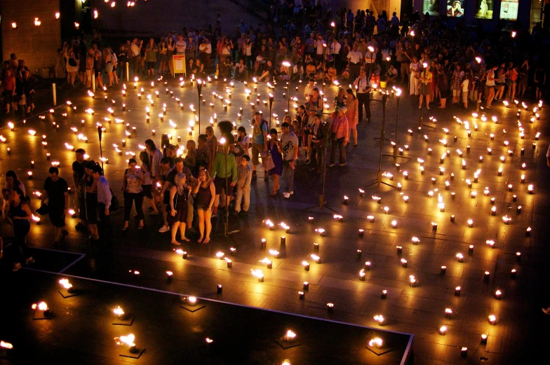 an aerial view of the lighted up walkway in a square