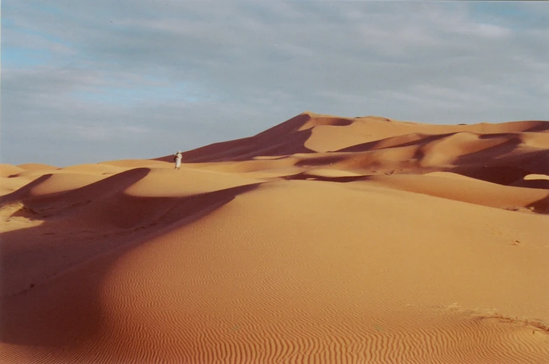 there are two people walking through the desert