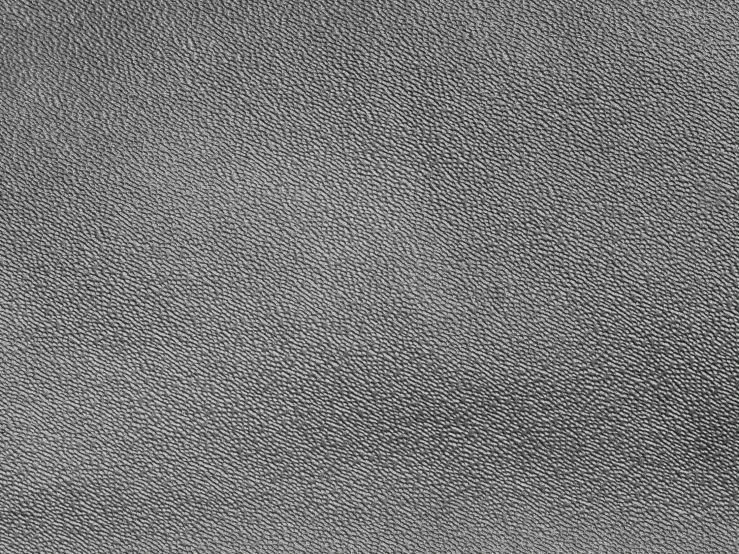 grey textured background with small patches of black and white