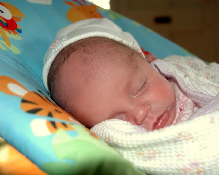 the baby is sleeping in the high chair