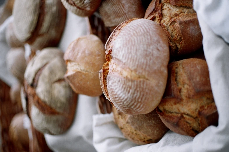 several loaves of bread are on display at a market