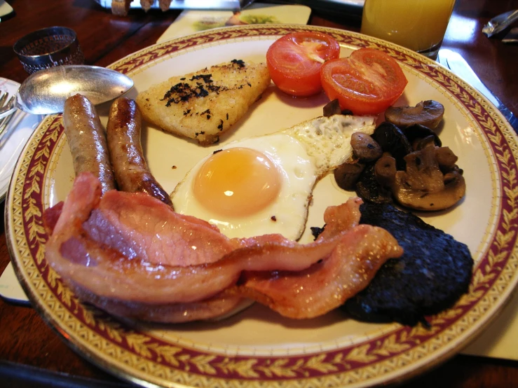 the plate is covered with several delicious breakfast foods