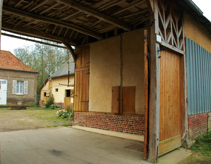 there is a small brick structure under a roof