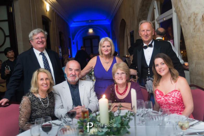 a group of people posing for a picture at a formal event