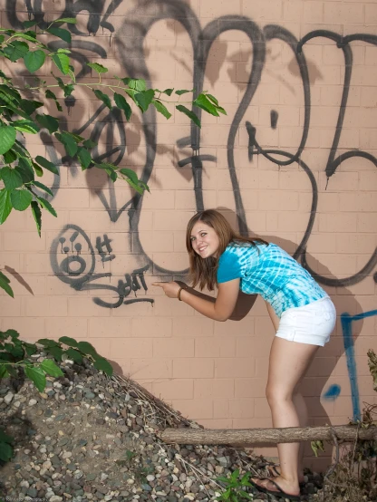 a  leaning against a wall with graffiti