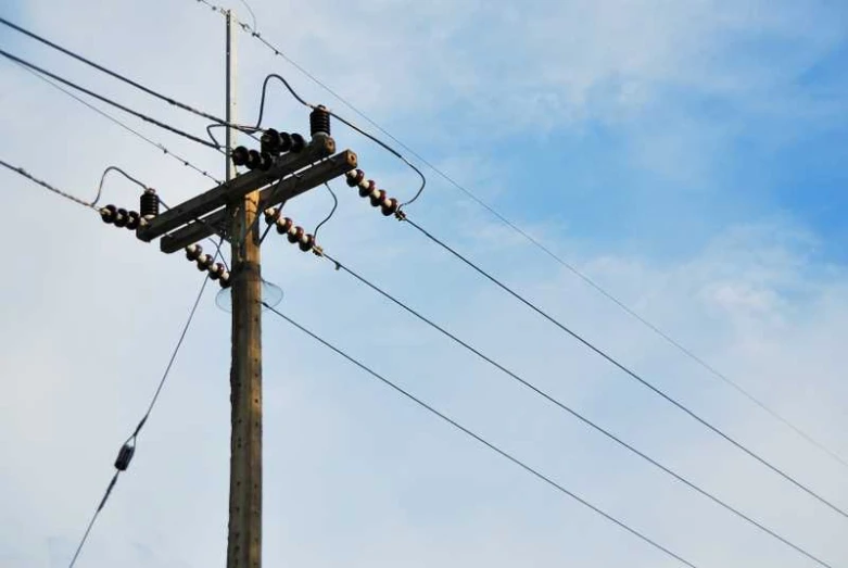 an electric pole has several wires hanging down