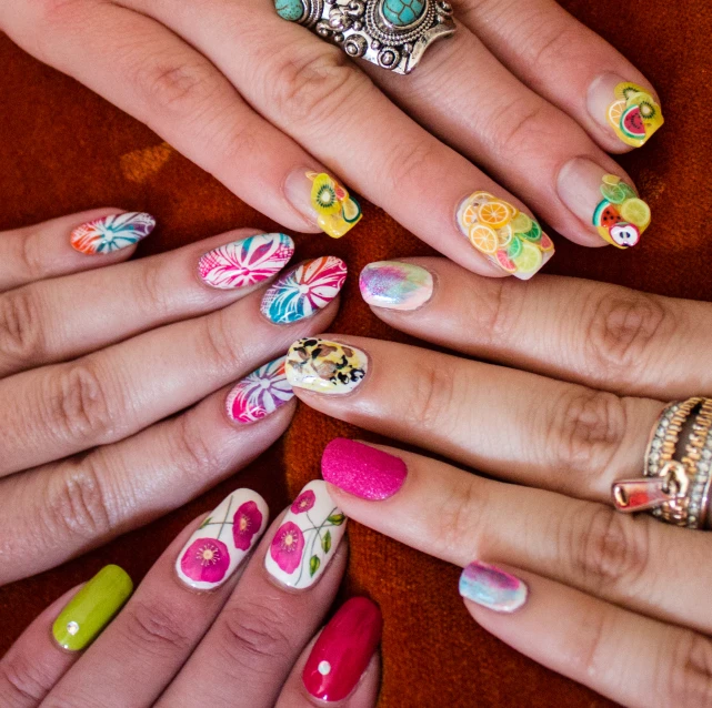 hands of various types with colorful decorated nail polish