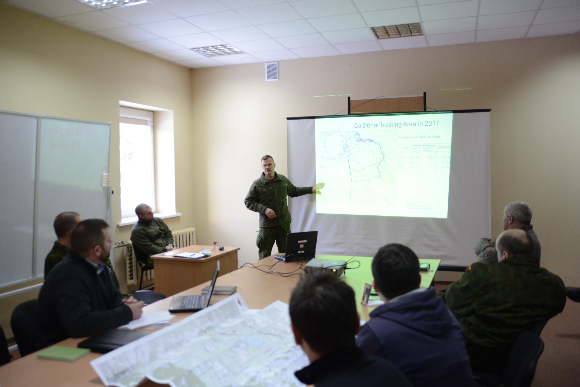 a man is giving a lecture to a group