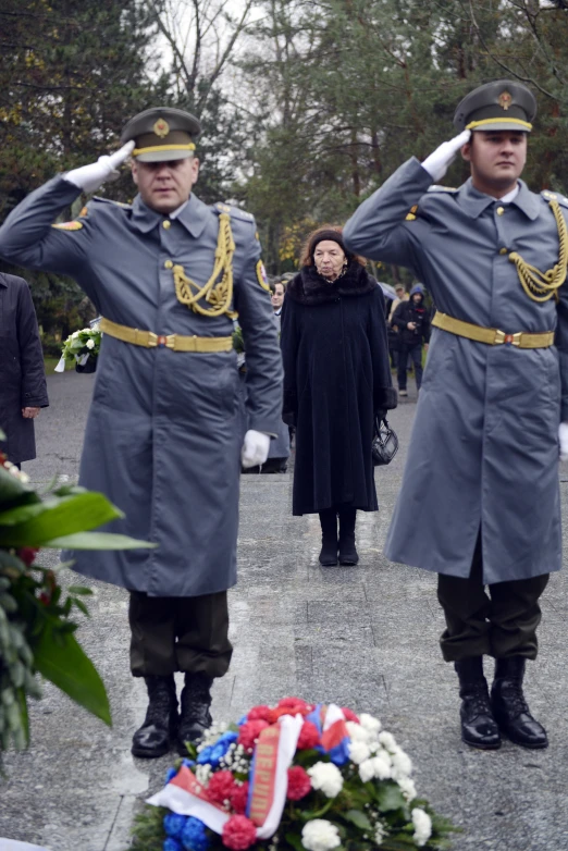 the two soldiers are watching the people in their coats place