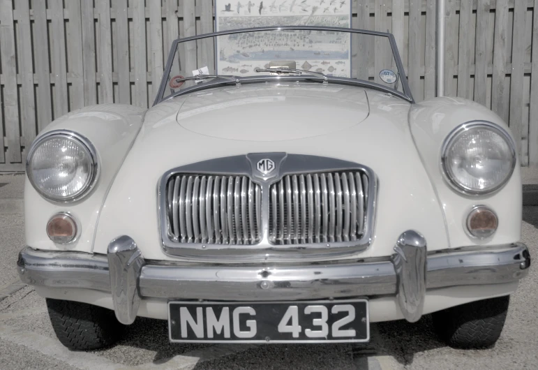 an old, classic white convertible car with the hood and hood popped