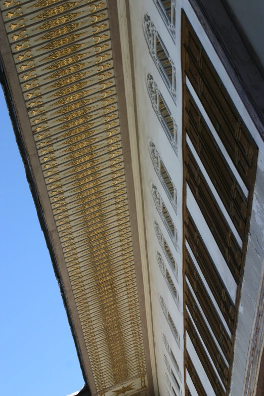 view of a building from underneath with street lights