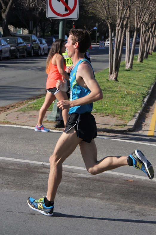 a man running down the road while wearing running shoes