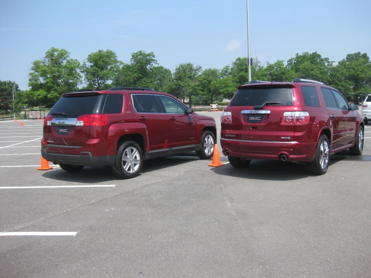 a pair of maroon jeeps in a parking lot