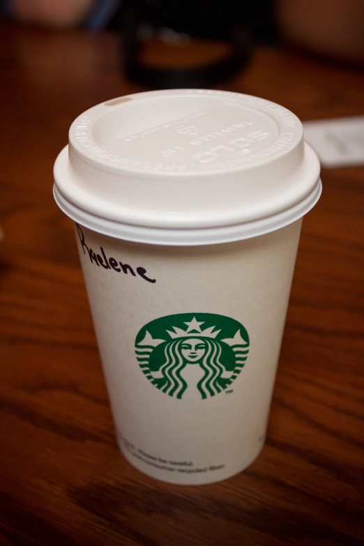 a starbucks coffee is shown on a wooden table