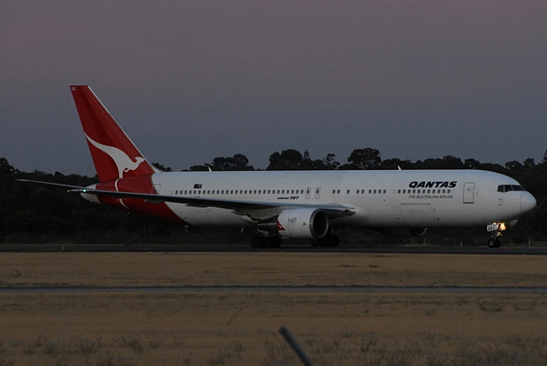 a large white jetliner on top of an airport runway