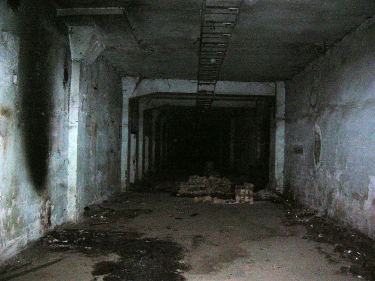 a long dark room that has been abandoned