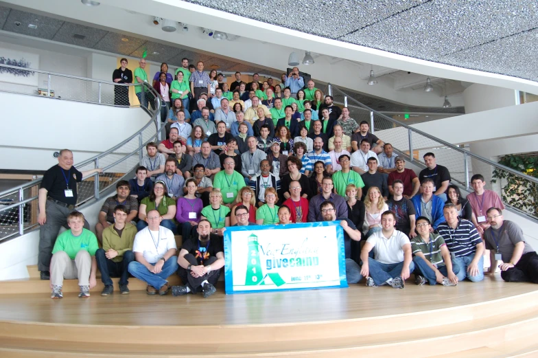 people sitting on a staircase and posing for a group po