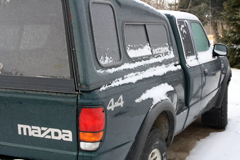 an image of the back end of a truck covered with snow