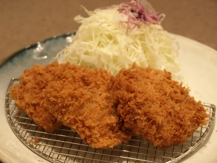 a close up of meat on a tray with coleslaw