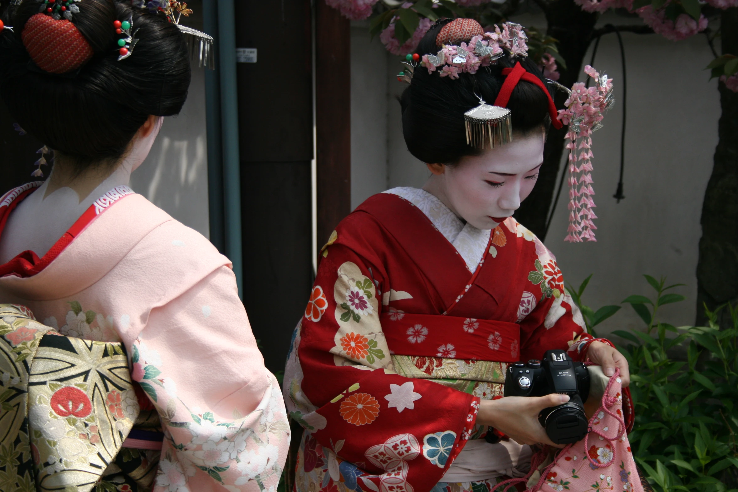 two asian geisha woman standing next to each other