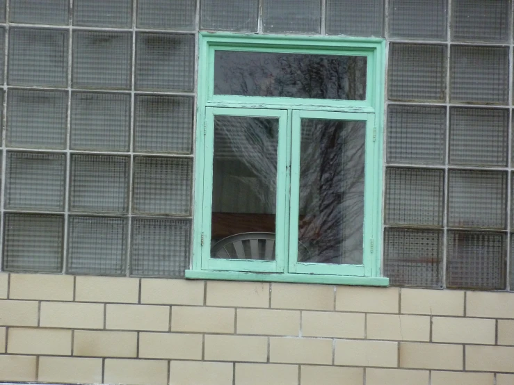 a building with windows sitting next to a block wall