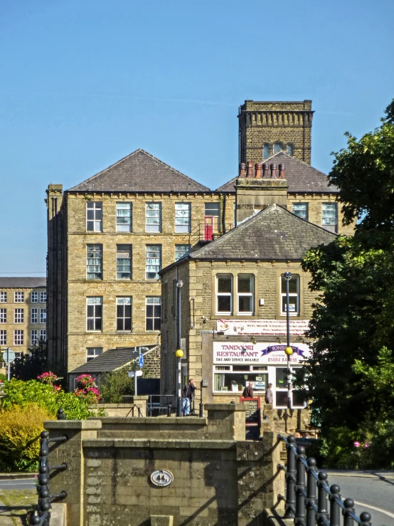 a tall stone building with two towers near trees