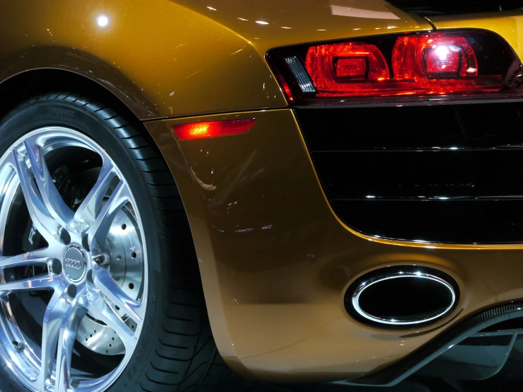 yellow sports car with a red tail light