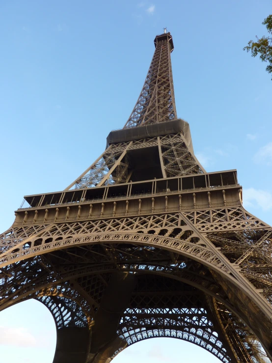 the front view of the eiffel tower against a blue sky