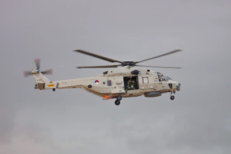 a large military helicopter flying through the air