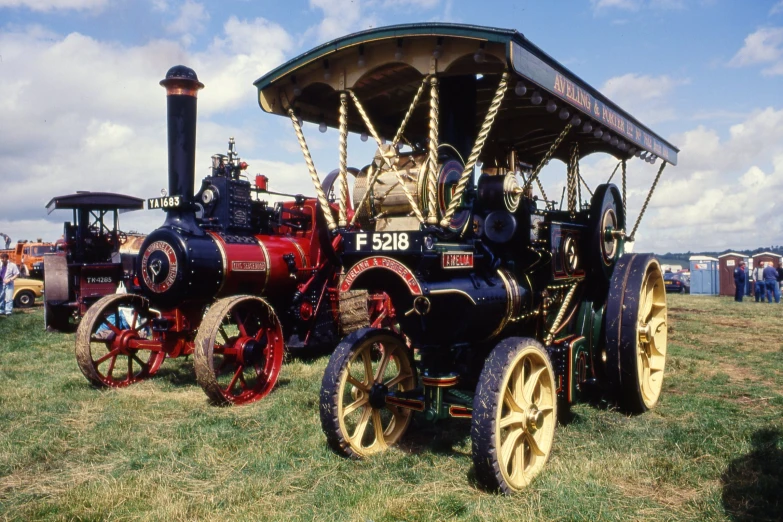 an antique steam engine parked in the grass