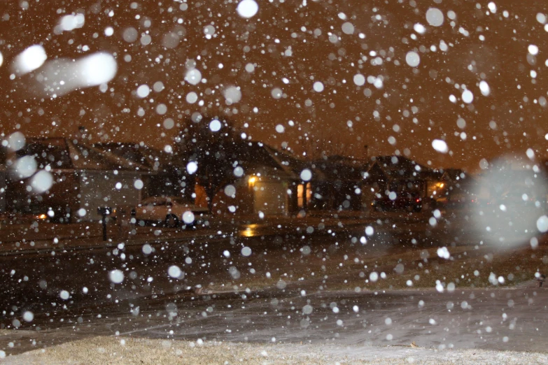 a snow storm is falling off on a street