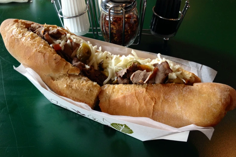 two sub sandwiches sitting on a table