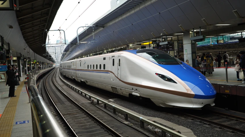 a long white train in a train station