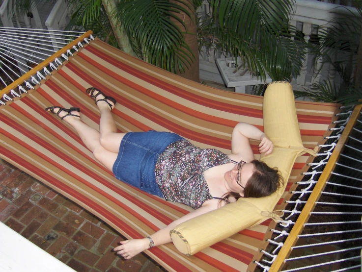 a woman laying in a hammock with a banana on it