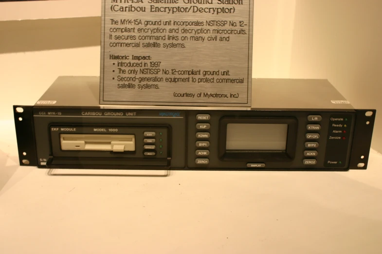 a radio sits on top of a table in front of an electronic warning sign