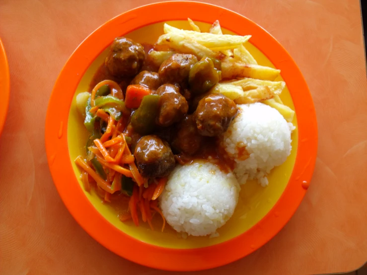 orange plate with rice and meat in it