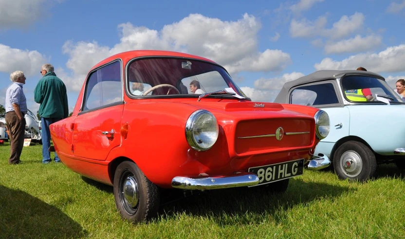 several old fashion cars on display in a field