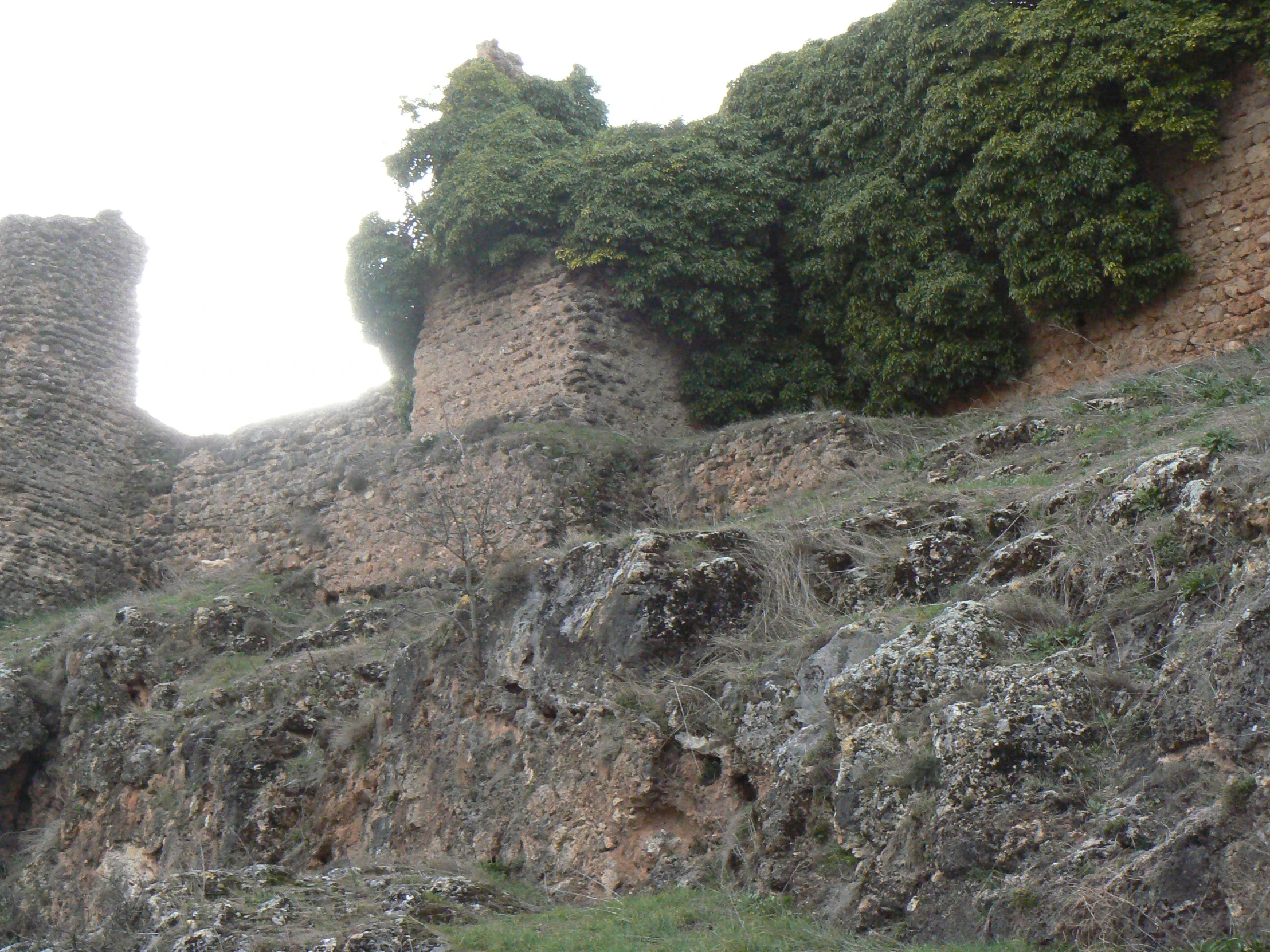 an old looking stone structure on a hillside